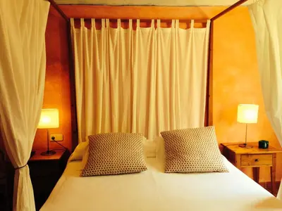 a bedroom with a bed with two pillows at Hostal l´Ou de Reig in Montseny