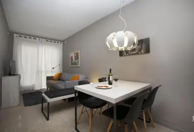 a living room with a table and chairs and a couch at Bcn Sagrada Familia Apartments in Barcelona