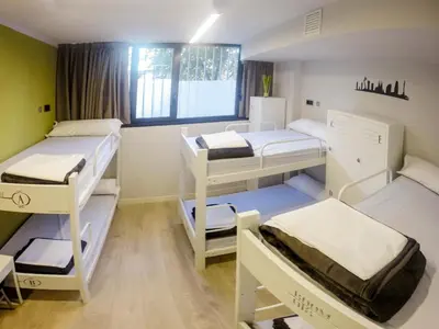a room with three bunk beds and a window at Room018BCN in Barcelona