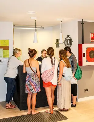 a group of women standing around a counter in a store at Room018BCN in Barcelona