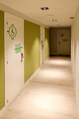 an empty hallway with green walls and wooden floors at Room018BCN in Barcelona