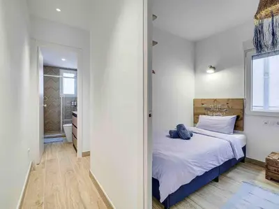 a bedroom with a large bed and a window at Casa Mandarina: 4 Bedrooms - 2 Terraces - Parking in Hospitalet de Llobregat