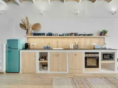 a kitchen with a blue refrigerator and wooden cabinets at Casa Mandarina: 4 Bedrooms - 2 Terraces - Parking in Hospitalet de Llobregat