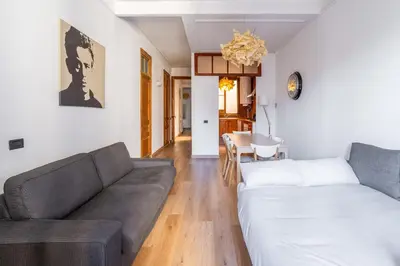 a living room with a couch and a table at The Collection Barcelona - Paseo St Joan classic 4BD for 10 guests in Barcelona