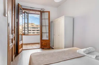a bedroom with a bed and a large window at The Collection Barcelona - Paseo St Joan classic 4BD for 10 guests in Barcelona