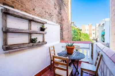 a dining room with a table and chairs and a blue door at The Collection Barcelona - Private terrace Attico 3BD in Gran de Gracia in Barcelona