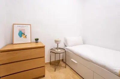 a white bedroom with a bed and a window at The Collection Barcelona - Private terrace Attico 3BD in Gran de Gracia in Barcelona
