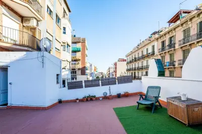 a balcony with a chair and a table on a building at The Collection Barcelona - Private terrace Attico 3BD in Gran de Gracia in Barcelona