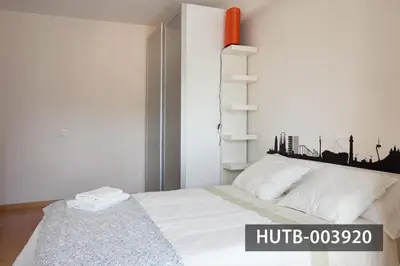 a bedroom with a white bed with a city skyline on it at Splash in Barcelona