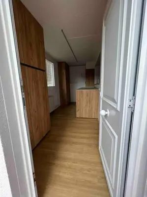 an empty hallway with a door and a room with a counter at Casa familiar en la playa con piscina in Teià