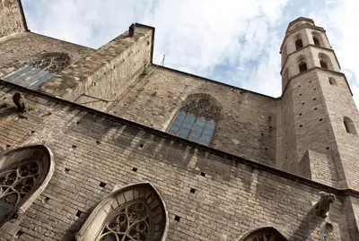 a large brick building with a clock tower on it at Best House Best Place in Barcelona