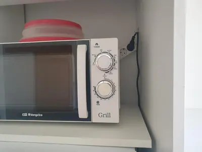 a washing machine with a bowl on top of it at Modern Loft in Terrassa in Terrassa