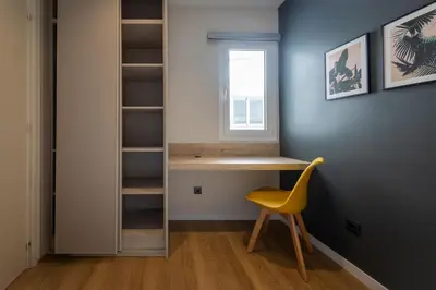 a room with a desk and a yellow chair at MadreMia - Chic Hub Barcelona in Hospitalet de Llobregat