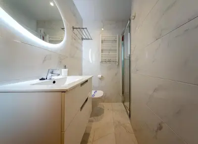 a bathroom with a sink and a toilet and a mirror at MadreMia - Chic Hub Barcelona in Hospitalet de Llobregat