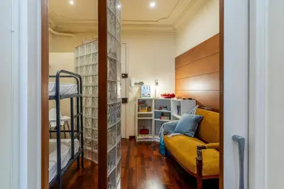 a room with a bunk bed and a couch at Canela Homes BARCELONA JARDINETS in Barcelona