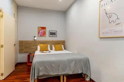 a bedroom with a bed with yellow pillows at Canela Homes BARCELONA JARDINETS in Barcelona