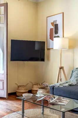 a living room with a couch and a table at Canela Homes BARCELONA JARDINETS in Barcelona