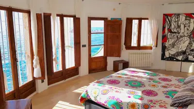 a bedroom with a bed and some windows at Tot Gaviota in Sitges