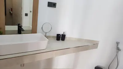 a bathroom with a white sink and a mirror at Tot Gaviota in Sitges