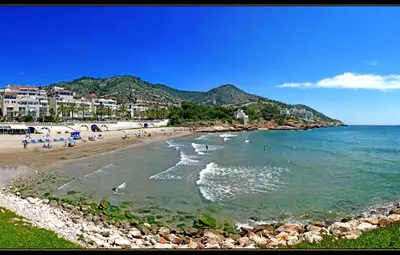 a beach with a group of people in the water at Tot Gaviota in Sitges
