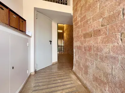 a hallway of a house with a brick wall at Stay U-nique Apartment Comte Urgell II in Barcelona