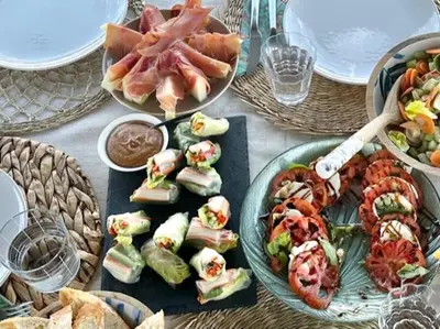 a table topped with plates of sandwiches and food at MotorYacht 21 avec équipage in Barcelona