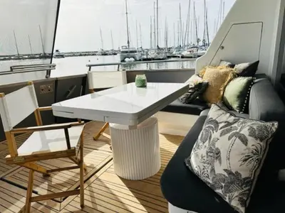 a table and chairs on a boat with a view of a harbor at MotorYacht 21 avec équipage in Barcelona