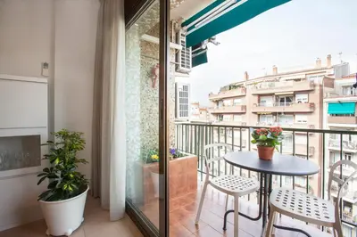 a balcony with a table and chairs and a view at Rosselló Apartment in Barcelona