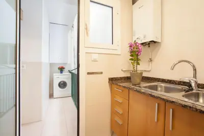 a kitchen with a sink and a washing machine at Rosselló Apartment in Barcelona