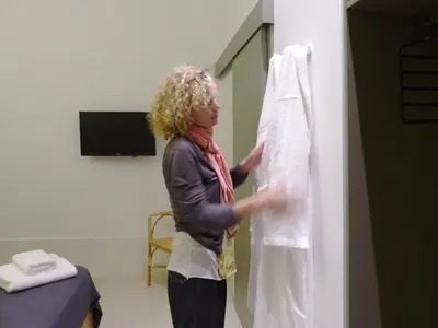a woman in a hospital room holding a towel at Casa Mathilda in Barcelona