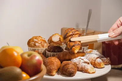 a plate of pastries and apples on a table at Casa Mathilda in Barcelona