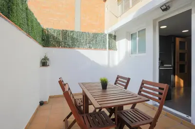 a wooden table and chairs on a patio at BBarcelona Sagrada Familia Terrace Flat in Barcelona