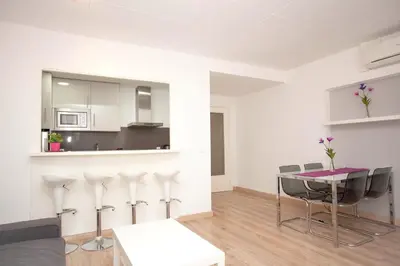 a kitchen and dining room with a table and chairs at Sitges Center & Beach with Sea View in Sitges