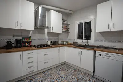 a white kitchen with white cabinets and a sink at Flat Top Manager in Barcelona