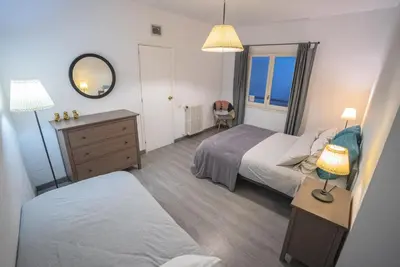 a bedroom with two beds and a dresser and a mirror at Flat Top Manager in Barcelona