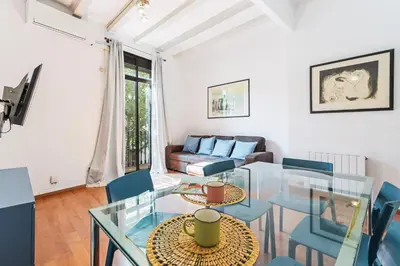 a living room with a glass table and chairs at Bright 2BR in Clot Desk Fiber Wi-Fi in Barcelona