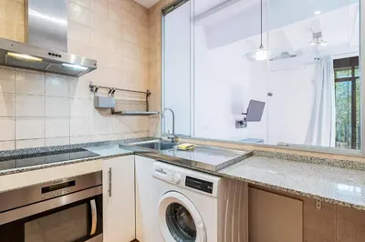 a kitchen with a washing machine and a sink at Bright 2BR in Clot Desk Fiber Wi-Fi in Barcelona