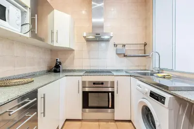 a kitchen with a sink and a dishwasher at Bright 2BR in Clot Desk Fiber Wi-Fi in Barcelona