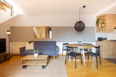 a living room with a blue couch and a table at Elegante dúplex en Terrassa, Barcelona in Terrassa