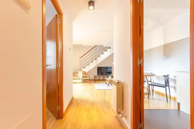 a hallway with a door leading to a dining room at Elegante dúplex en Terrassa, Barcelona in Terrassa