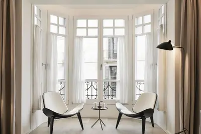 two chairs and a table in front of a window at BCN Town Apartments Portaferrissa in Barcelona