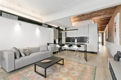 a living room with a couch and a table at BCN Town Apartments Portaferrissa in Barcelona