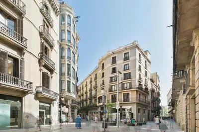 a city street with buildings and people walking on the street at BCN Town Apartments Portaferrissa in Barcelona