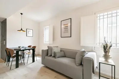 a living room with a couch and a table at BCN Town Apartments Portaferrissa in Barcelona