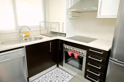 a small kitchen with a sink and a stove at Homenfun Barcelona Paseo de Gracia Diagonal in Barcelona