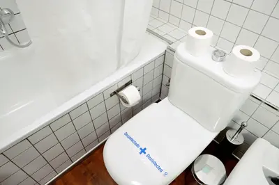a bathroom with a toilet with two rolls of toilet paper on it at Homenfun Barcelona Paseo de Gracia Diagonal in Barcelona