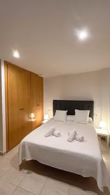 a bedroom with a large bed with two towels on it at M1 Céntrico y con balcón in Terrassa
