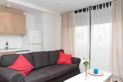 a living room with a gray couch and red pillows at Port V Apart centrico con estilo 21 in Barcelona