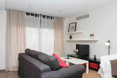 a living room with a couch and a tv at Port V Apart centrico con estilo 21 in Barcelona