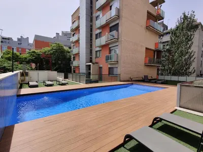 a swimming pool on the roof of a building at Family apartment Forum in Sant Adria de Besos